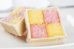Get this homemade Battenberg Cake recipe and enjoy a slice of history. Delicious strips of cake embraced by luscious filling and enrobed in almond marzipan.