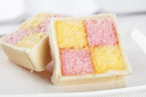 Get this homemade Battenberg Cake recipe and enjoy a slice of history. Delicious strips of cake embraced by luscious filling and enrobed in almond marzipan.