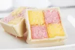 Get this homemade Battenberg Cake recipe and enjoy a slice of history. Delicious strips of cake embraced by luscious filling and enrobed in almond marzipan.