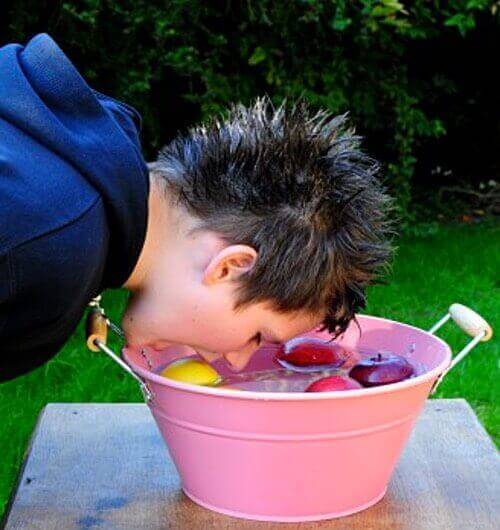 Young Boy Bobbing for Apples