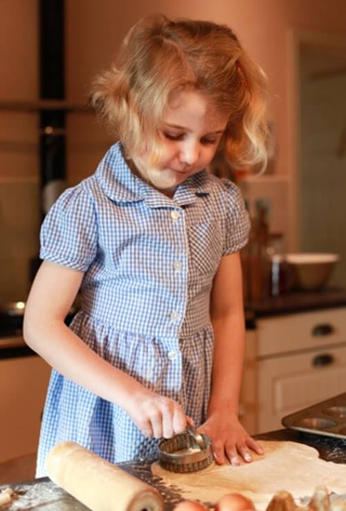 Little Girl Cutting Out Cookies
