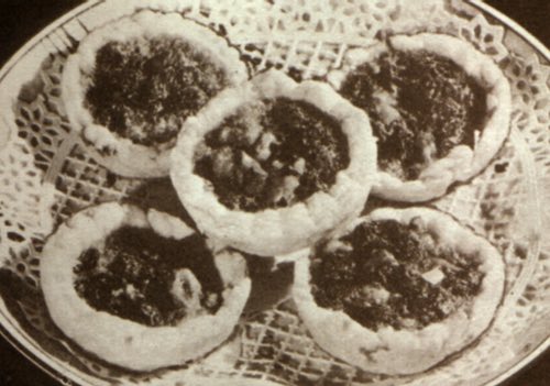 Plateful of Homemade Butter Tarts Arranged on a Lace Doily