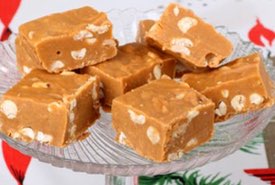 Pieces of Peanut Butter Fudge on a Glass Candy Stand
