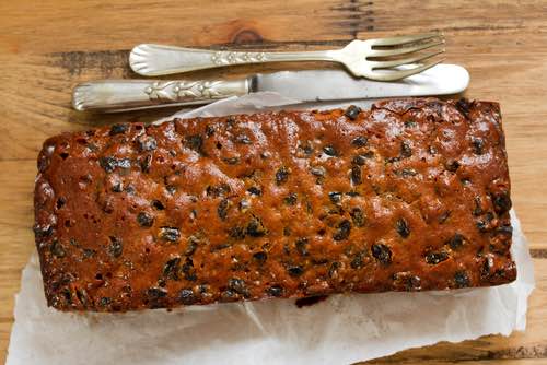 Traditional English Fruitcake with Knife and Fork on a Table