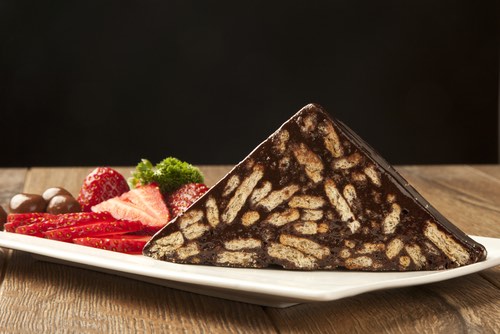 Slice of Chocolate Biscuit Cake Served With Strawberries