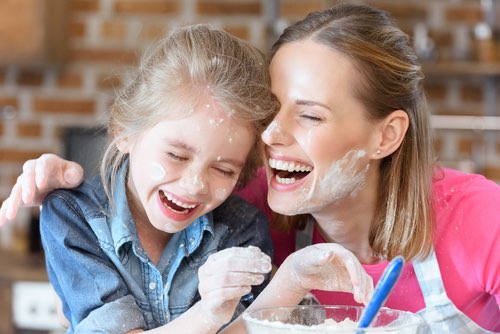 Mother and Daughter Laughing While Baking