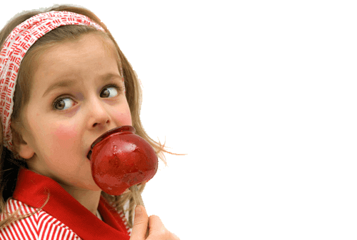 Little Girl Eating a Red Candy Apple