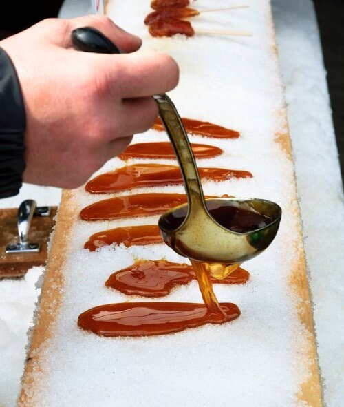 Making Snow Taffy on a Wooden Plank Covered with Freshly Fallen Snow