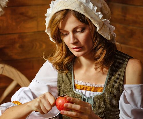 Woman in Renaissance Costume Peeling an Apple