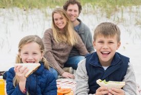 Young Family Enjoying a Beach Picnic