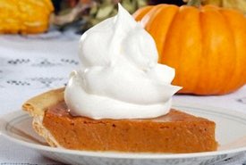 Slice of Pumpkin Pie with a Whipped Cream Topping